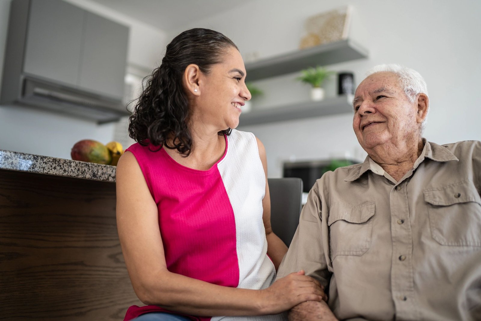 Senior man talking with a caregiver at home