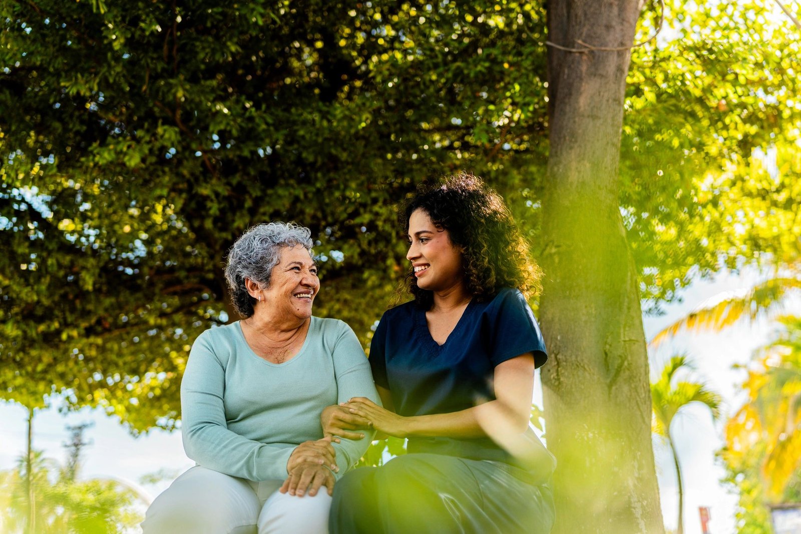 Caregiver supporting an older adult outdoors