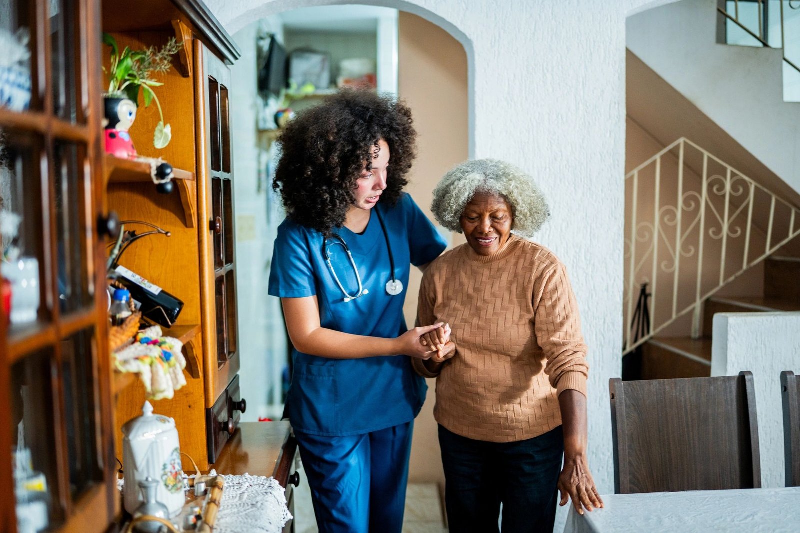 Care assistant helping a patient walk
